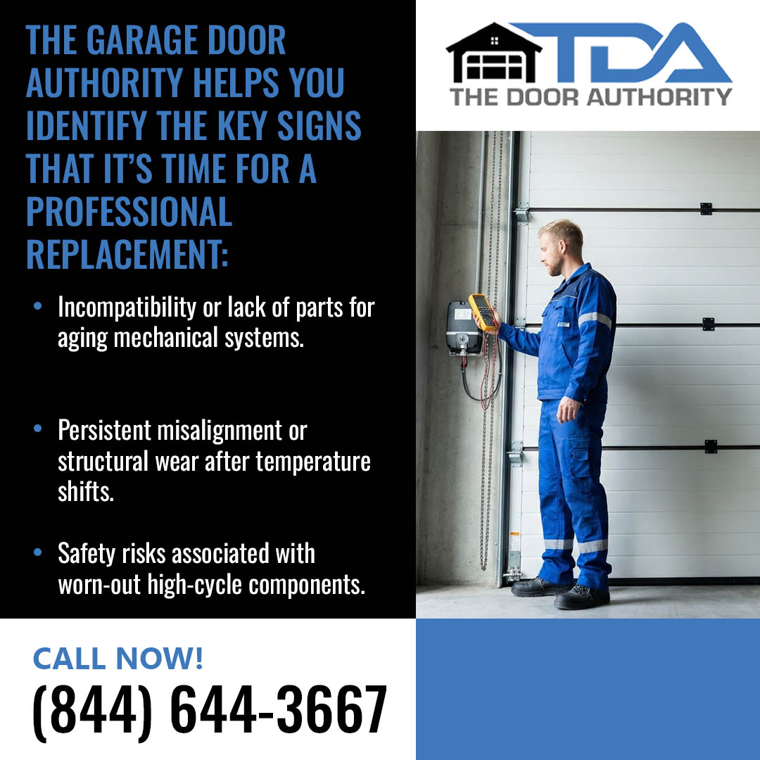 Technician inspecting a commercial-style garage door system for wear and safety issues